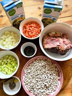 bowls filled with food sitting on top of a wooden table