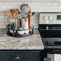 a kitchen counter with utensils and pots on it