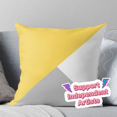 a yellow and grey pillow with the words support independent artists on it