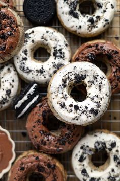 there are many donuts with chocolate and sprinkles on the cooling rack