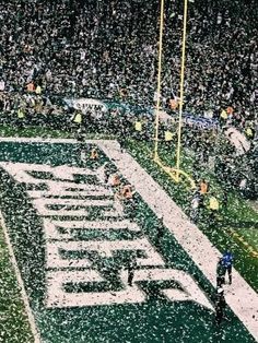 the football field is covered in snow as fans watch from the sidelines during a game