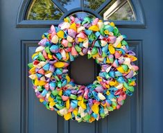 a colorful wreath is hanging on the front door