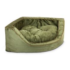 a dog bed with a green cover on it's sides and a brown pillow in the middle