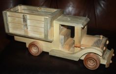 a wooden toy truck sitting on top of a table