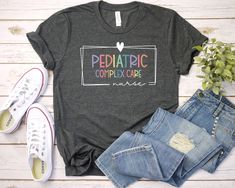 a t - shirt that says teaching on a two day next to jeans and sneakers