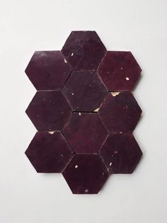 a piece of wood that has been cut into hexagons on the wall