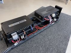 an array of electronic equipment sitting on top of a carpeted floor in a room