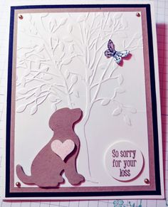 a card with a dog and butterfly on it, sitting in front of a tree