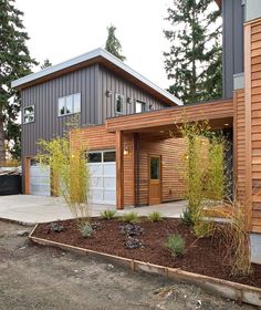 a modern house with wood siding and garage