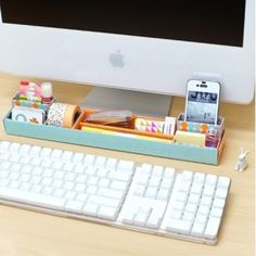 an apple computer sitting on top of a wooden desk next to a keyboard and mouse