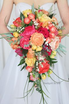 a bridal holding a bouquet of colorful flowers