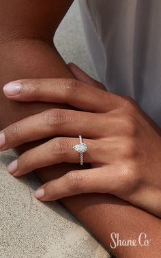 a woman's hand with a diamond ring on it