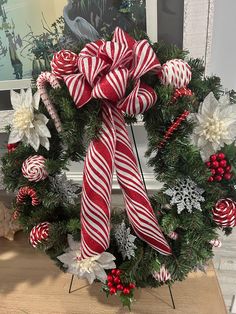 a wreath decorated with candy canes and poinsettis