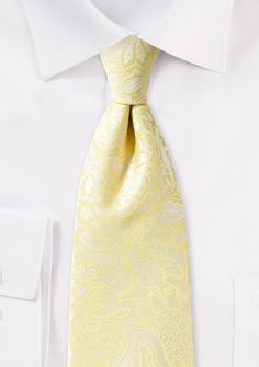 Introducing the Canary Floral Paisley Necktie, a striking accessory that radiates warmth and charm. The vibrant canary yellow hue, combined with intricate floral paisley patterns, creates a necktie that is as bold as it is elegant. This versatile piece effortlessly complements a range of styles, making it a perfect choice for shopping for men's suits or adding a touch of sophistication to a wedding ensemble. The Canary Floral Paisley Necktie is a true statement piece, exuding confidence and char Classic Yellow Wedding Tie, Formal Yellow Tie, Classic Yellow Tie For Formal Occasions, Elegant Yellow Tie For Formal Occasions, Elegant Yellow Ties For Formal Occasions, Grey Slacks, Yellow Tie, Paisley Fabric, Paisley Tie