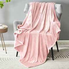 a pink blanket sitting on top of a chair