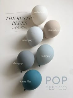 several different colors of balloons sitting on top of a white surface with the words pop fest co above them