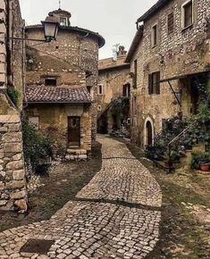 an old cobblestone street with stone buildings