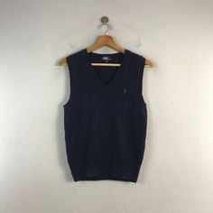 PLEASE READ DESCRIPTION BELOW BEFORE BUYING👇🏻 *ITEM:Polo Ralph Lauren Vest *ITEM DETAILS: 👇🏻 Please be aware that all vintage items will usually show a few signs of wear or fading due to age, but anything visible such as stains or holes, and serious flaws have been photographed.For any further information on this item please contact us and we will be happy to help. *SIZE:SMALL *ACTUAL SIZE MEASUREMENT: 👇🏻 *PIT TO PIT(WIDTH):17"INCHES *LENGTH(FROM SHOULDER): 23"INCHES  *ALL MEASUREMENTS ARE TAKEN WITH THE GARMENT FLAT ON THE GROUND *VIEW FULL SHOP HERE: https://www.etsy.com/shop/Tracstore *SHIPPING: (WITH ONLINE TRACKING NUMBER ) *DHL EXPRESS SHIPPING:4-6 BUSINESS DAYS *Don't Worry About Customs Tax or Fees. I usually Declare As 'Gifts' And Low Value  *ANY QUESTION WILL ANSWER WITHIN Blue Knit V-neck Vest, Casual Sleeveless Sweater For Winter, Casual Sleeveless Winter Sweater, Casual Sleeveless Sweater Vest, Casual Fitted Sleeveless Sweater Vest, Fitted Sleeveless Sweater Vest Casual, Casual Navy Outerwear With V-neck, Casual Blue Knit Vest, Blue Cotton Sweater Vest For Fall