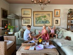 two people sitting on a couch in a living room