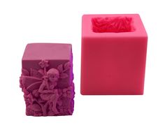 a pink and purple candle holder sitting next to each other