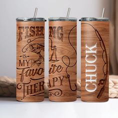 three wooden tumblers with fishing designs on them