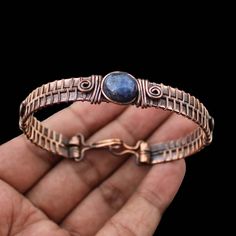 Lapis Lazuli Cuff Bracelet Copper Wire Wrapped Bangle Cuff Adjustable Bangle Gemstone Bracelet Handmade Bangle Copper Bangle Lapis Jewelry Main Stone - Lapis Lazuli Bangle Length - 2.50 - 2.75" Inches (Adjustable) Bangle Width  -  0.50 Inches Metal                  -  Copper Copper Has Been Used For Jewelry Making For Thousands Of Years, Dating Back To Ancient Civilisations Such As The Egyptians, Romans, And Aztecs. Copper Was Valued For Its Beauty, Versatility, And Durability, And Was Often Use Artisan Adjustable Bangle Bracelets, Adjustable Artisan Blue Bangle, Adjustable Artisan Bangle, Artisan Adjustable Round Bangle, Handmade Adjustable Artisan Bangle, Adjustable Artisan Metal Bangle, Handmade Artisan Metal Bangle, Handmade Metal Artisan Bangle, Adjustable Metal Bracelets With Gemstone