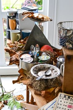 an assortment of food items sitting on top of a wooden table next to a window