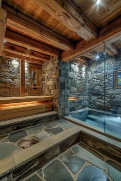 an indoor hot tub with stone walls and flooring