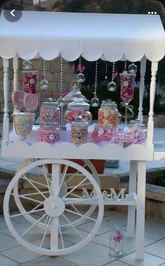 a candy cart with lots of candies and lollipops on it's sides