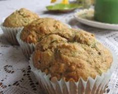 three muffins sitting on top of a table next to a cup of coffee