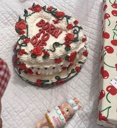 a birthday cake with the number 50 on it next to a roll of wrapping paper