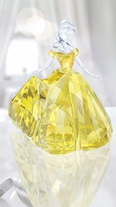 a yellow glass bottle sitting on top of a table