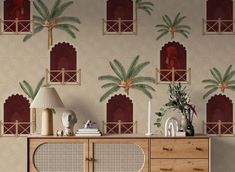 a sideboard with palm trees on it in front of a wallpapered background