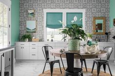 a dining room table with chairs and a potted plant