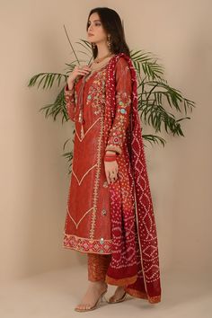 Beautiful pick for festivity which has stone embellishment on neckline with contrasting floral work of powder blue, pink, beige silk thread with crystal beads, Sitara, sequins work with kora and pearls side tassels which gives it epitome look followed with straight jamawar pant and statement contrast chuniri dupatta to finish the look elegantly. Shirt Fabric: Pure jacquard Shirt Length: 45” Pant Fabric: Jamawar Dupatta Fabric: Pure silk chuniri Shirt, Pant & dupatta color: Rust orange All outfit Jamavar Pants, Outfits Formal, Luxury Pret, Eid Outfits, Floral Work, Shirt Pant, Beige Silk, Jacquard Shirt, Designer Outfits