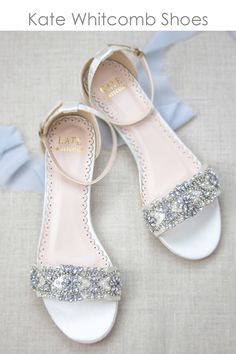 a pair of white shoes with silver sequins on the toes and heel straps