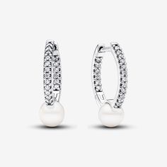 Keep it classy with our Treated Freshwater Cultured Pearl Hoop Earrings. Crafted in sterling silver, the slightly squared hoops showcase a delicate concaved section featuring a treated freshwater cultured pearl. The click closure ensures a secure fit. This pair, an everyday addition to the Pandora Timeless collection, celebrates the timeless allure of pearls and the artful interplay of materials. Please note each treated freshwater cultured pearl is unique and can vary in size and color; normal Pandora Pearl, Bracelet Pandora, Everyday Gifts, Halo Earrings Studs, Pearl Hoop Earrings, Freshwater Cultured Pearls, Pavlova, Pandora Jewelry, Sterling Silver Earrings Studs