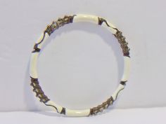 White and gold bangle bracelet. White enamel with gold metal accents. Add it to your jewelry wardrobe. Pre owned. In good condition. All sales are final and as is. Thank you for looking. You may also love this: https://www.etsy.com/listing/448818876/vintage-black-white-graduated-bead?ga_search_query=white%2Bjewelry&ref=shop_items_search_53 White Wire Wrapped Bangle Bracelet, Adjustable White Metal Beaded Bracelet, White Metal Jewelry For Friendship, Adjustable Wire Wrapped White Bracelets, White Adjustable Wire Wrapped Bracelets, Adjustable White Wire Wrapped Bracelets, Bohemian White Bangle Jewelry, Handmade White Beaded Metal Bracelets, Nickel Free White Stretch Bracelet As Gift