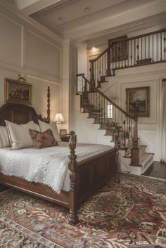 a large bed sitting under a stair case next to a wooden bannister on top of a carpeted floor