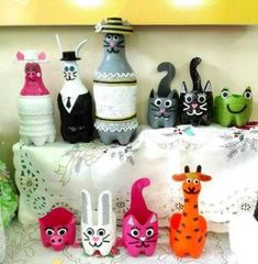 there are many different items on the table with cats and mice painted on them, including vases