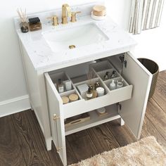 a white sink sitting under a bathroom vanity