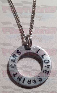 a silver necklace with the words love is all around it and an inscription that says i love