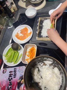 a person is preparing food on a stove top with utensils and other dishes