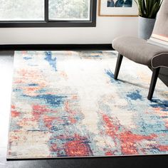 a living room area with a chair, rug and window in the background is shown