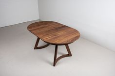 a wooden table sitting on top of a white floor