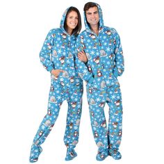 two people in matching pajamas standing next to each other with snowflakes on them