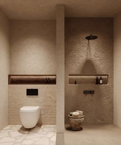 a bathroom with a white toilet sitting next to a wall mounted shower faucet