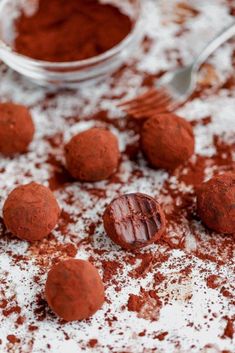 chocolate truffles and powdered sugar on a table