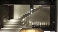 a room with some stairs and lights on the wall next to it is lit up