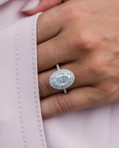 a woman's hand with a diamond ring on it